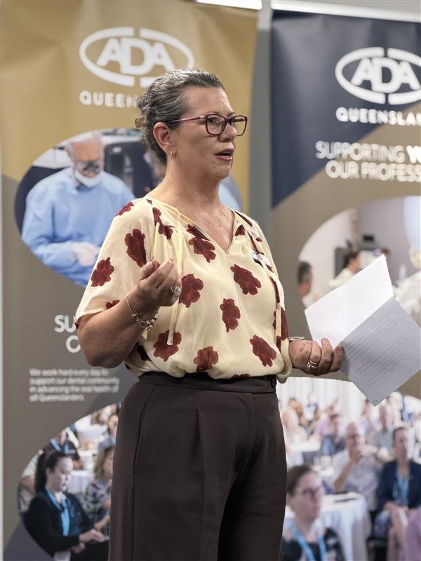 Dr Kelly Hennessy addressing members at an ADAQ event